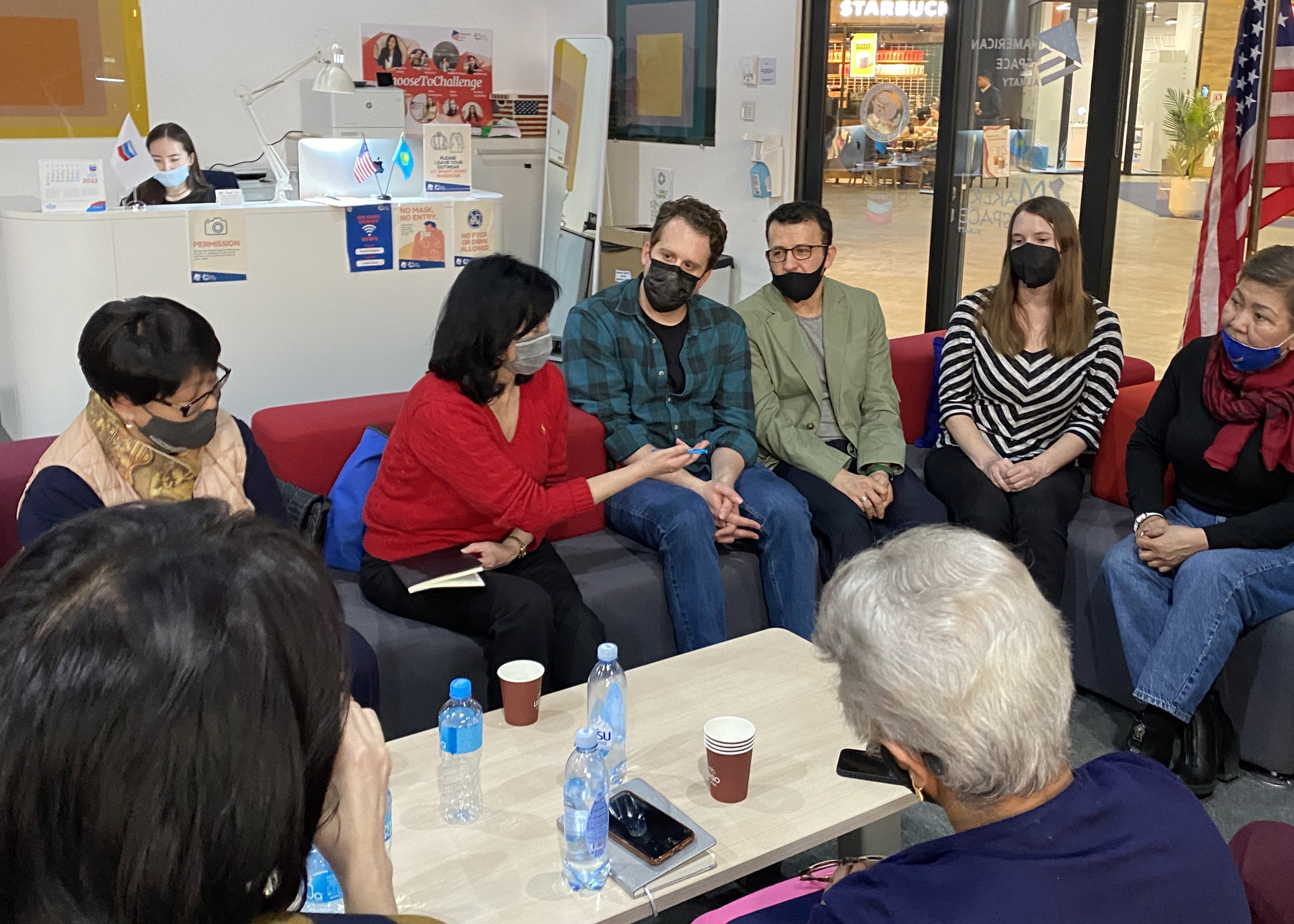 Group of people sitting around table in discussion