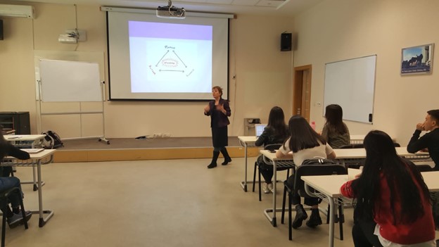 Fulbrighter standing at front of classroom teaching