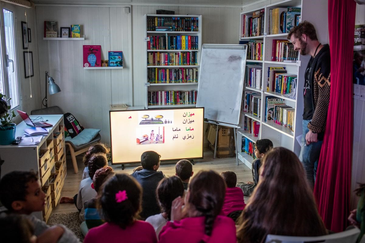 Man teaching classroom of children